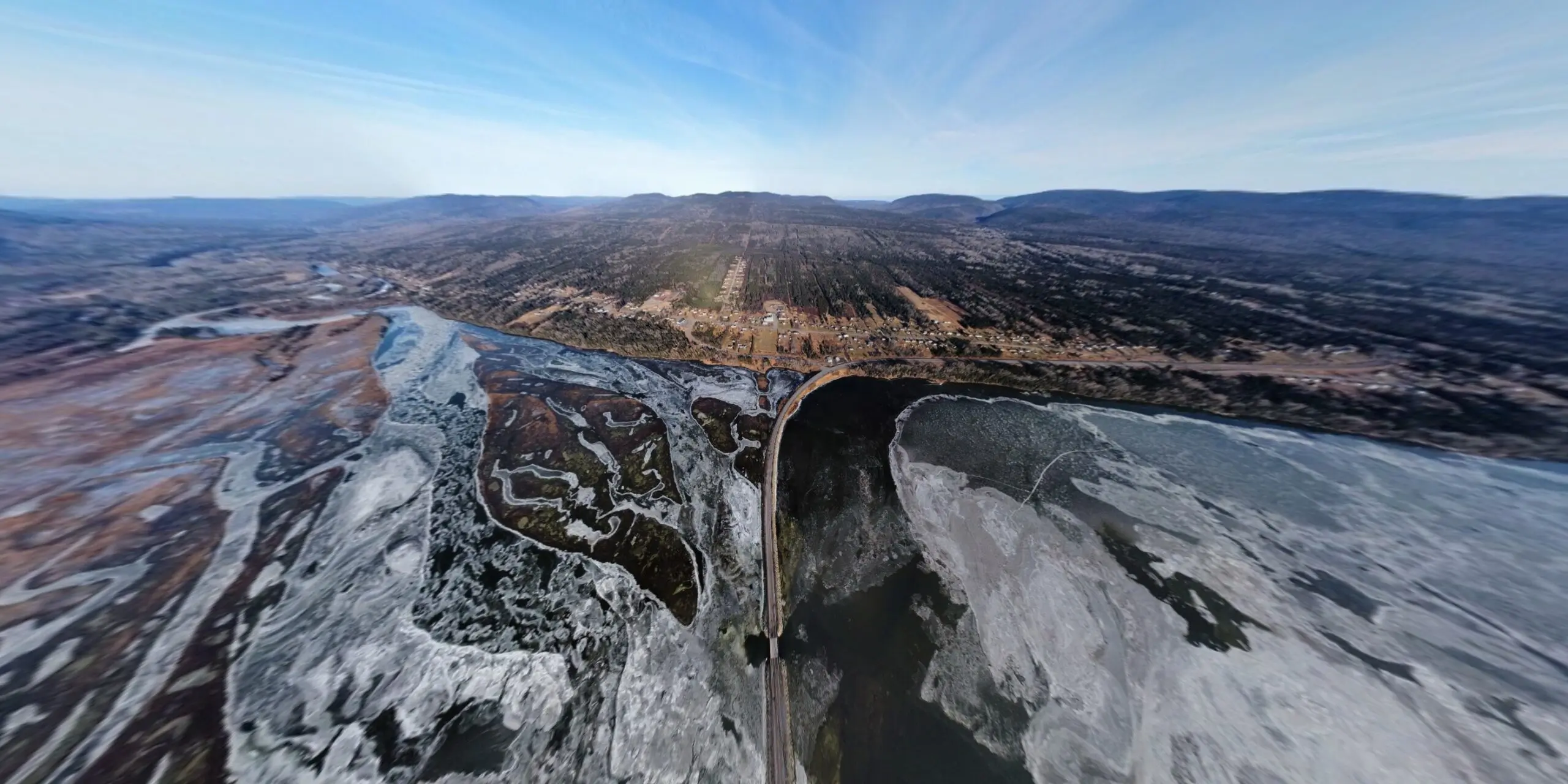 Découvrez une vue aérienne saisissante de la traverse de Saint-Majorique près de Gaspé, capturée en hiver sans neige. Cette image révèle la beauté brute et sauvage de la région, avec ses routes sinueuses traversant un paysage de conifères et de collines. Les nuances de gris et de brun dominent, offrant un contraste unique avec les saisons plus typiques de la neige abondante. La clarté de l'image permet d'apprécier les détails subtils du terrain et de la végétation, mettant en lumière la tranquillité et l'austérité de ce paysage hivernal.